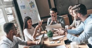 Person sharing her ideas confidently with her colleagues.